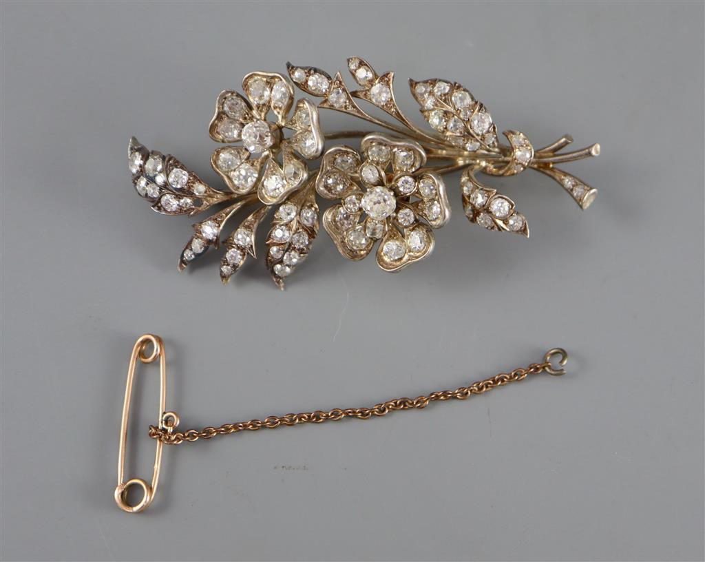 A Victorian gold, silver and graduated old round and cushion cut diamond set trembleuse floral spray brooch,